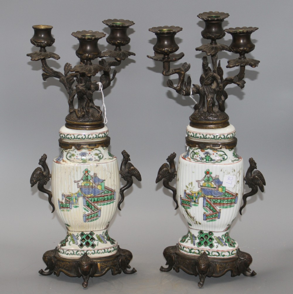 A pair of Samson famille verte style bronze mounted candelabra, with rustic branches and dragon handles, height 41cm